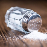 Old,Wooden,Table,With,A,Salt,Shaker,(close-up,Shot;,Selective