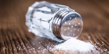 Old,Wooden,Table,With,A,Salt,Shaker,(close-up,Shot;,Selective