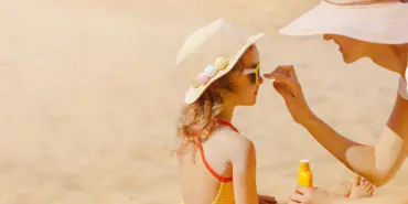 Mom,Carefully,Smears,Her,Child's,Face,With,Protective,Cream,On