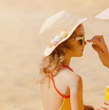 Mom,Carefully,Smears,Her,Child's,Face,With,Protective,Cream,On