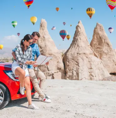 Happy,Couple,With,Map,On,Vacation,By,Car,In,Cappadocia