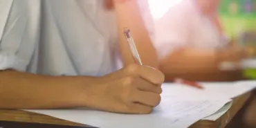 Closeup,To,Hand,Of,Student,Holding,Pen,And,Taking,Exam