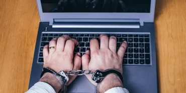 silver-laptop-on-the-table-with-silver-handcuffs-2023-11-27-05-29-48-utc-1720257305