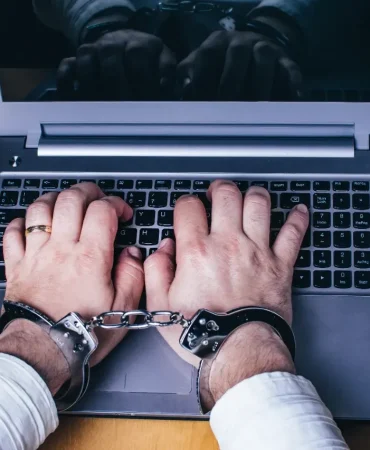 silver-laptop-on-the-table-with-silver-handcuffs-2023-11-27-05-29-48-utc-1720257305
