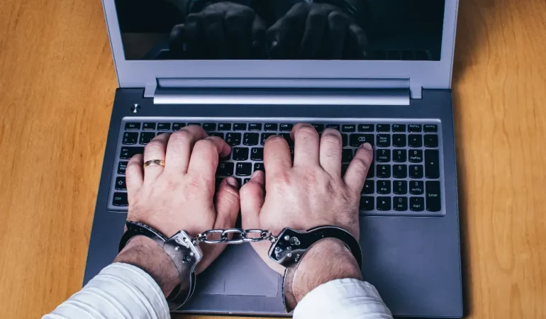 silver-laptop-on-the-table-with-silver-handcuffs-2023-11-27-05-29-48-utc-1720257305